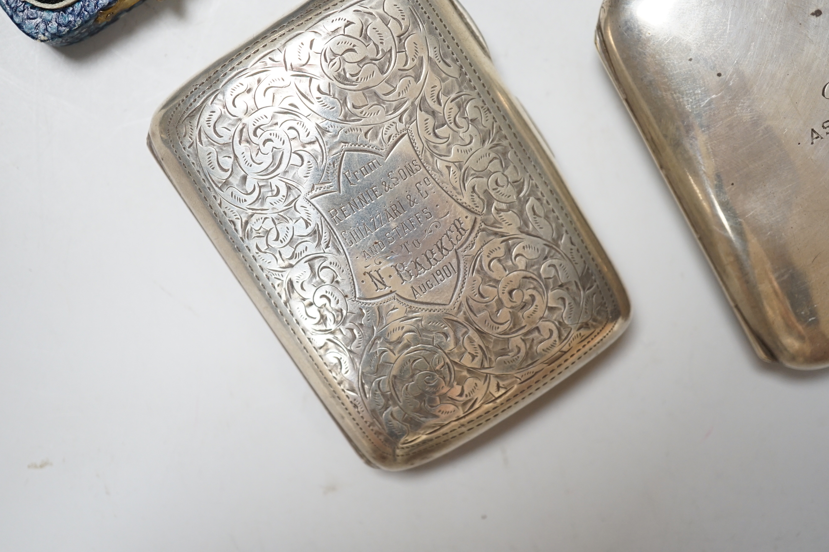 An Edwardian engraved silver cigarette case, 1901, 76 grams, a George V cigarette case with inscription from the Durban Pilots 1922, 102 grams and a cased set of six George V teaspoons, 58 grams